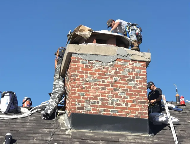 Scituate Chimney Sweep installing a custom chimney crown in Scituate, MA