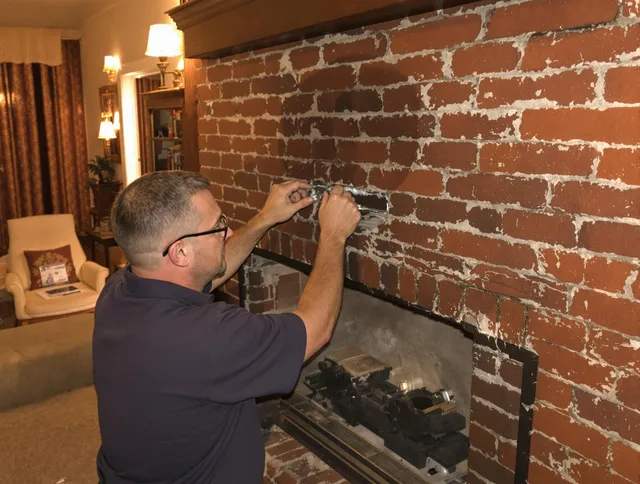 Scituate Chimney Sweep expert fixing a fireplace in Scituate, MA